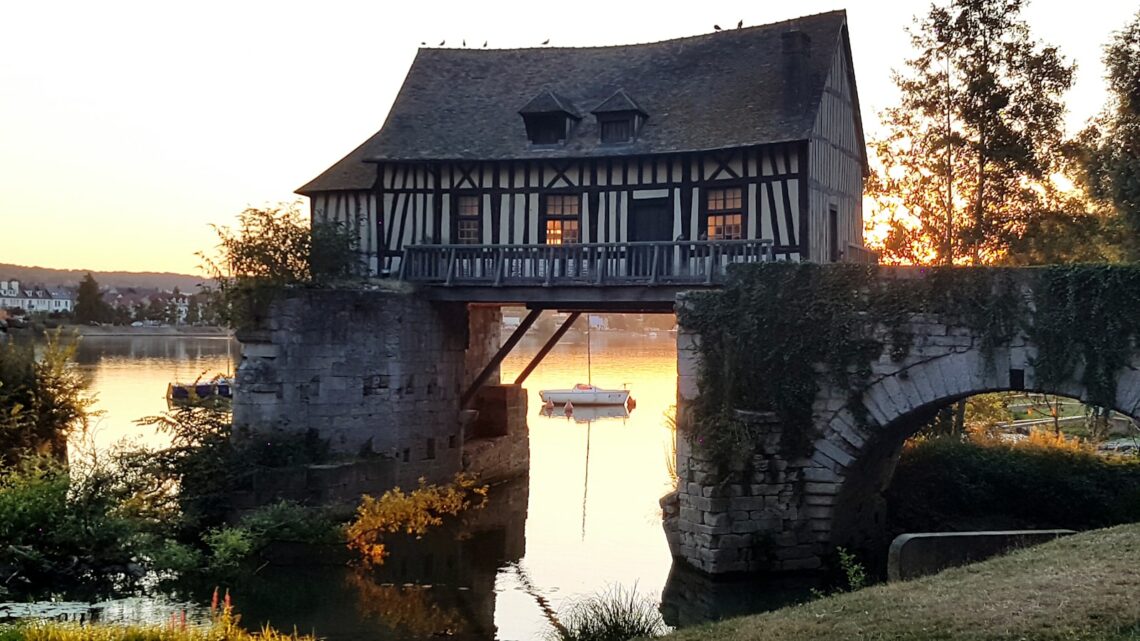 a bridge over a body of water with a boat on it